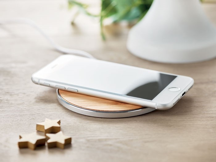 gadget scrivania e ufficio base di ricarica wireless con smartphone su scrivania in legno